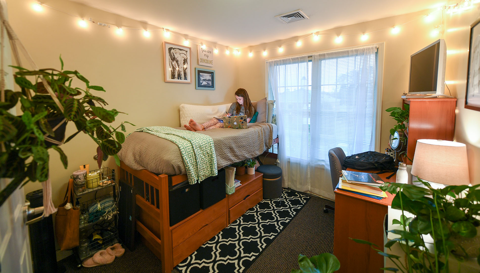 girl on laptop in a dorm room